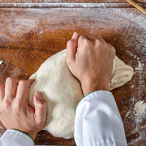 Image of a man kneading dough
