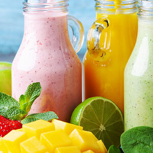 Image of 5 jars of smoothies surrounded by colorful fruit